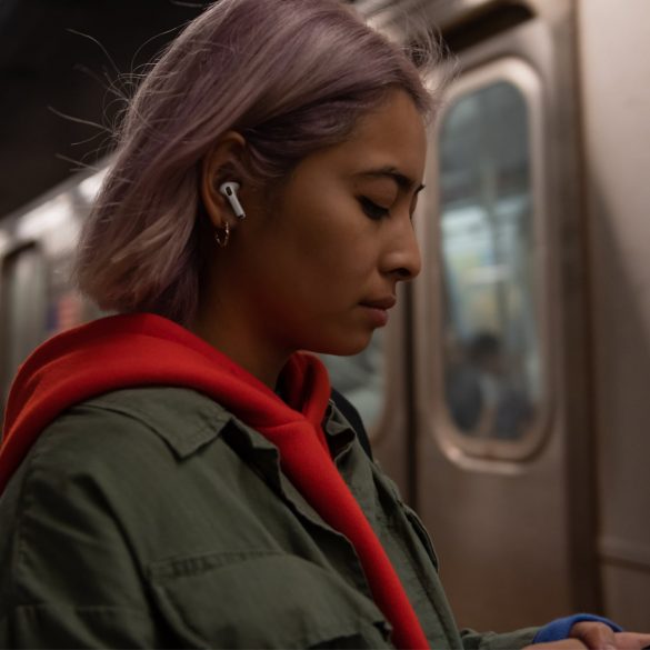 Girl Wearing AirPods Pro on Train
